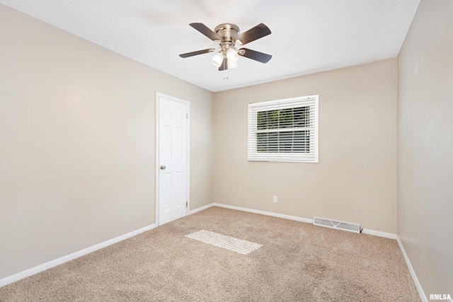 carpeted empty room with a textured ceiling and ceiling fan