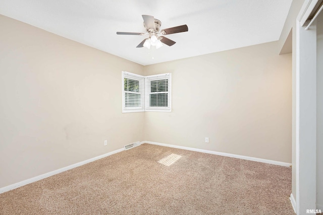 spare room featuring carpet and ceiling fan