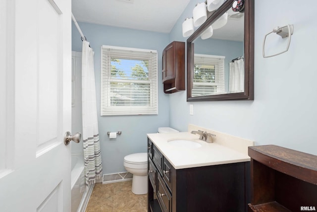 full bathroom featuring shower / bath combo, a healthy amount of sunlight, toilet, and vanity