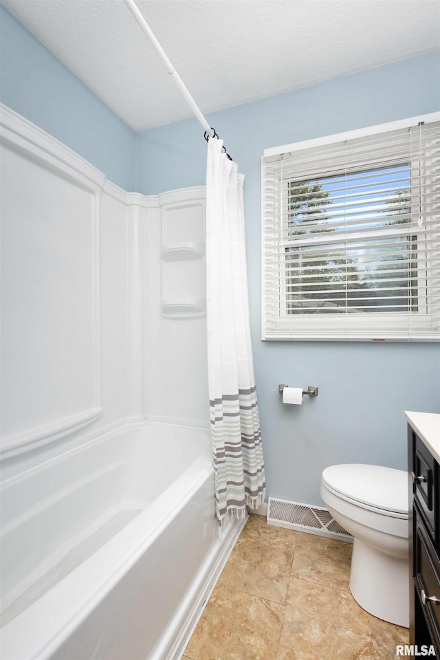 full bathroom featuring vanity, shower / bath combo with shower curtain, and toilet