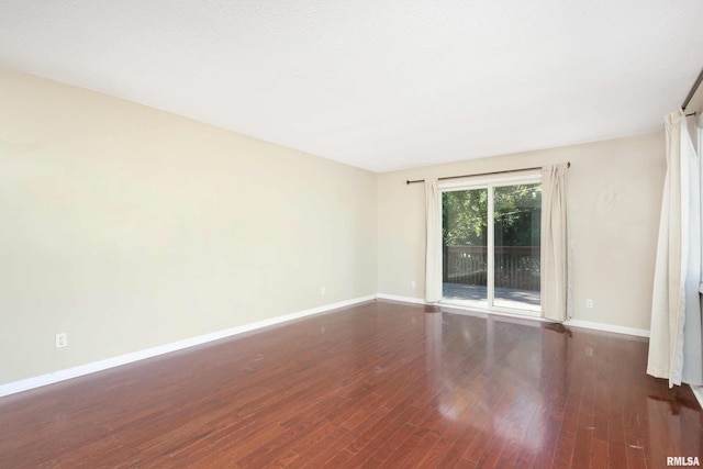 unfurnished room featuring dark wood-type flooring