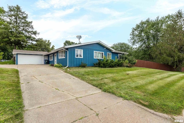 view of front of property with a garage and a front lawn