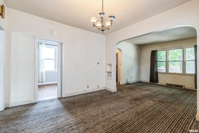 spare room featuring dark colored carpet