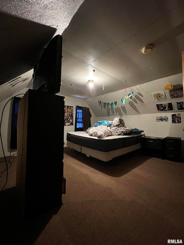 bedroom featuring carpet flooring, a textured ceiling, and vaulted ceiling