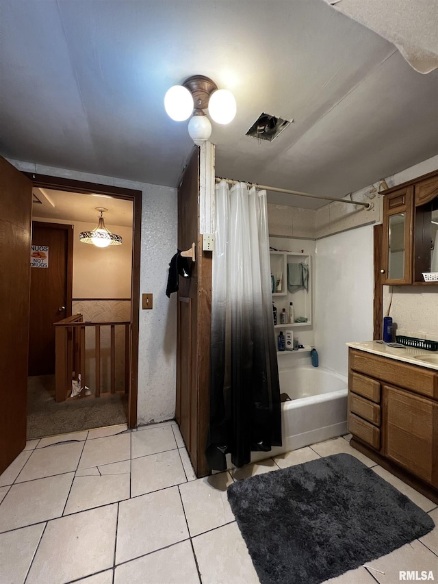 bathroom with shower / bath combo with shower curtain, tile patterned flooring, visible vents, and vanity