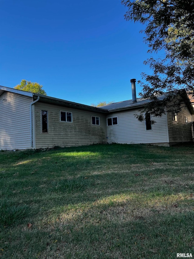 rear view of property with a yard