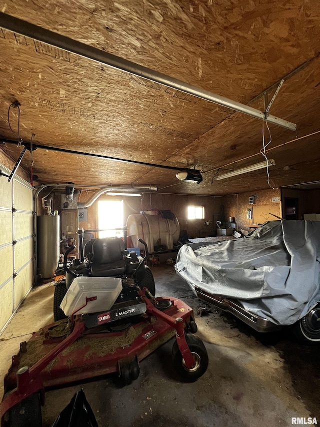 garage with a garage door opener and gas water heater