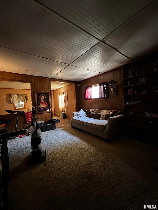 carpeted cinema room featuring wooden walls