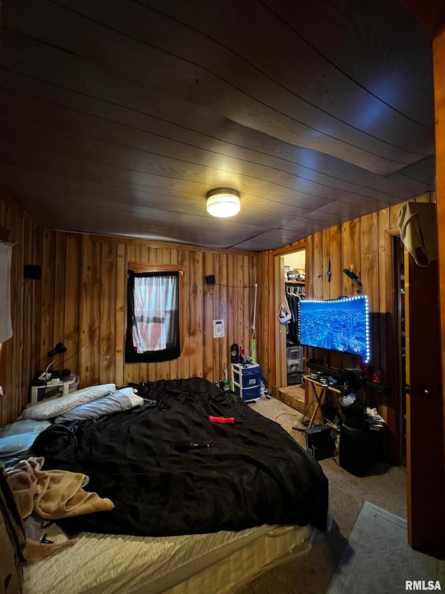 bedroom with wood walls, wooden ceiling, and carpet flooring