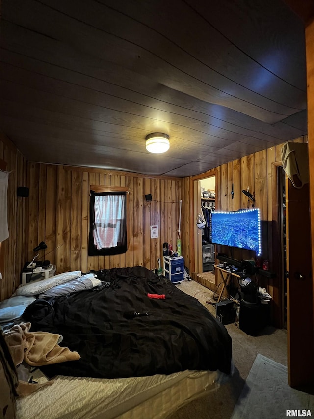 carpeted bedroom featuring wood ceiling and wooden walls