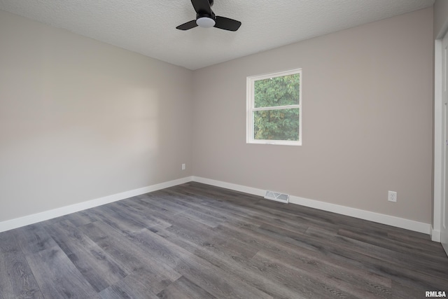 unfurnished room with ceiling fan, a textured ceiling, and dark hardwood / wood-style flooring