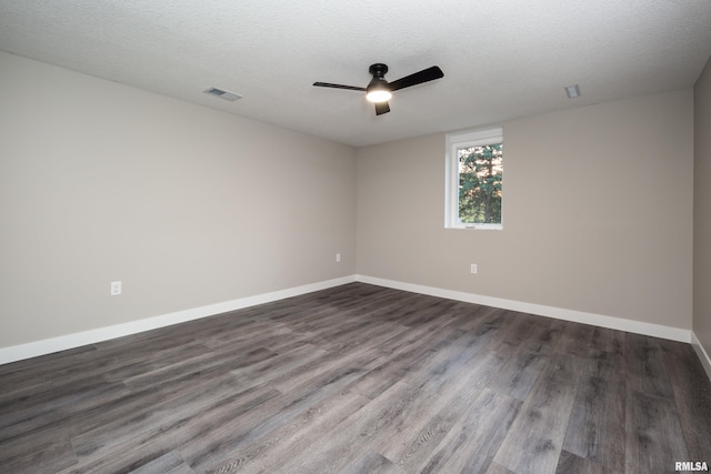 empty room with ceiling fan, a textured ceiling, and dark wood-type flooring