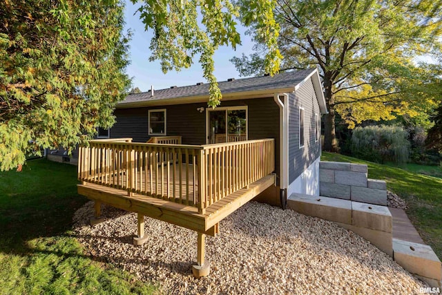 back of property featuring a yard and a wooden deck