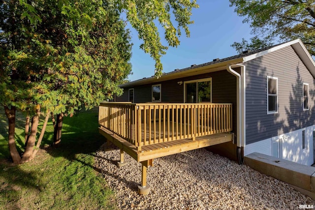 wooden deck featuring a lawn