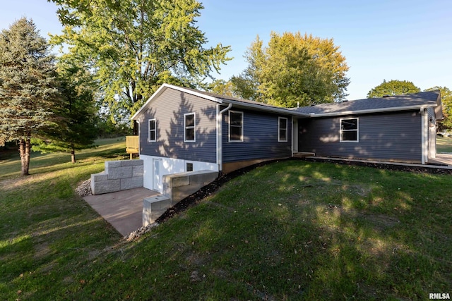 rear view of property with a lawn