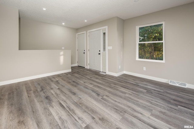 foyer with light hardwood / wood-style floors and a textured ceiling