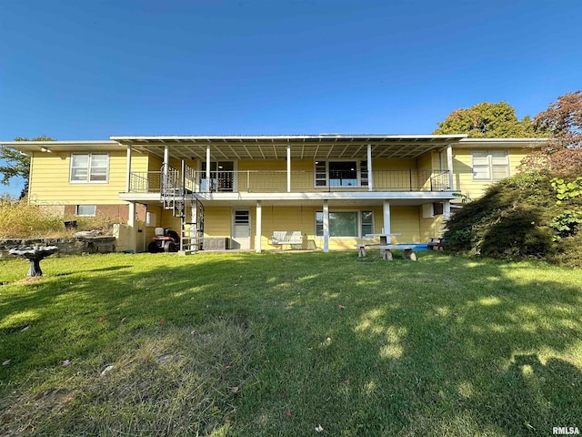 back of property with a balcony and a lawn