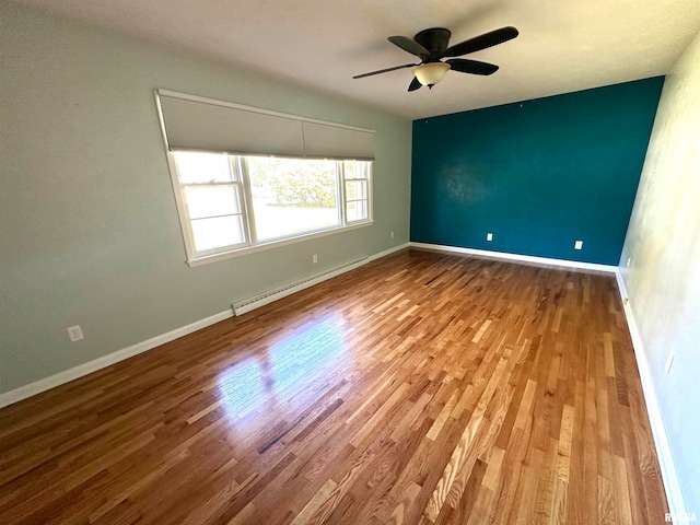 empty room with ceiling fan, hardwood / wood-style flooring, and baseboard heating