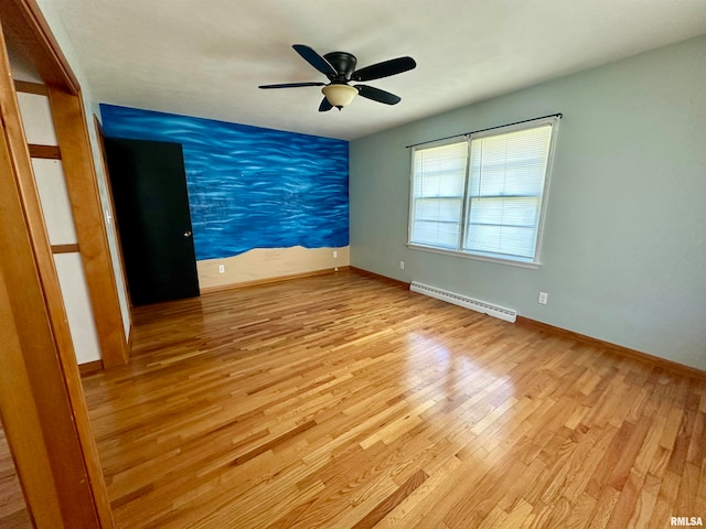 unfurnished room featuring light hardwood / wood-style flooring, a baseboard heating unit, and ceiling fan