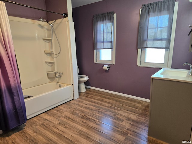 full bathroom with hardwood / wood-style floors, vanity, shower / tub combo with curtain, and toilet