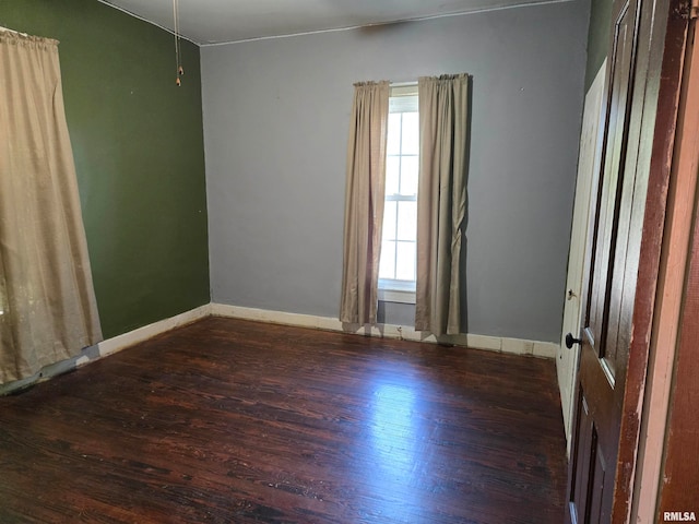 unfurnished room with dark hardwood / wood-style flooring