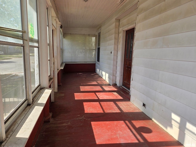 hall featuring wooden walls