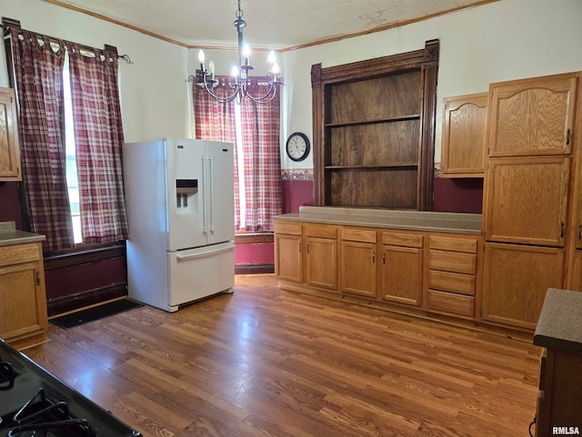 kitchen with ornamental molding, decorative light fixtures, dark wood-type flooring, white refrigerator with ice dispenser, and an inviting chandelier