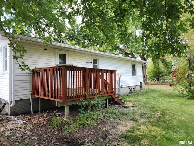 back of property with a lawn and a deck