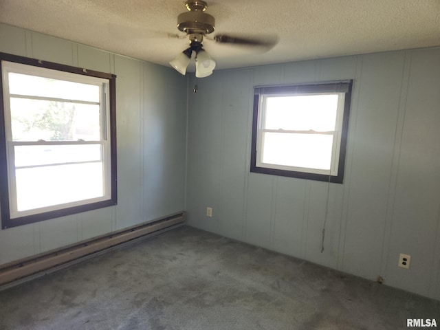 carpeted empty room featuring ceiling fan, a baseboard radiator, and a textured ceiling