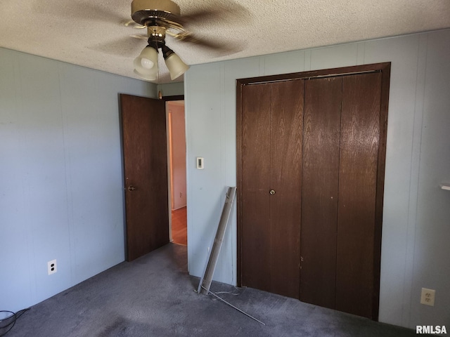 136 W 5th Ave, Woodhull, IL 61490 - unfurnished bedroom with a decorative wall, a closet, carpet flooring, a textured ceiling, and a ceiling fan