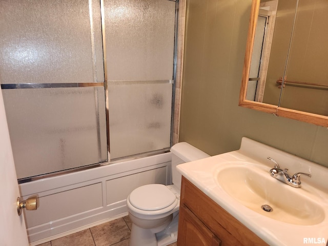 full bathroom with vanity, tile patterned floors, toilet, and combined bath / shower with glass door