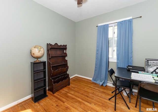 office with hardwood / wood-style flooring and ceiling fan