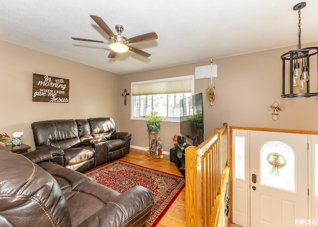 living room featuring ceiling fan and wood-type flooring