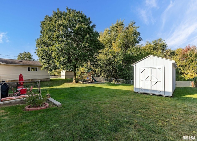 view of yard with a playground and a storage shed