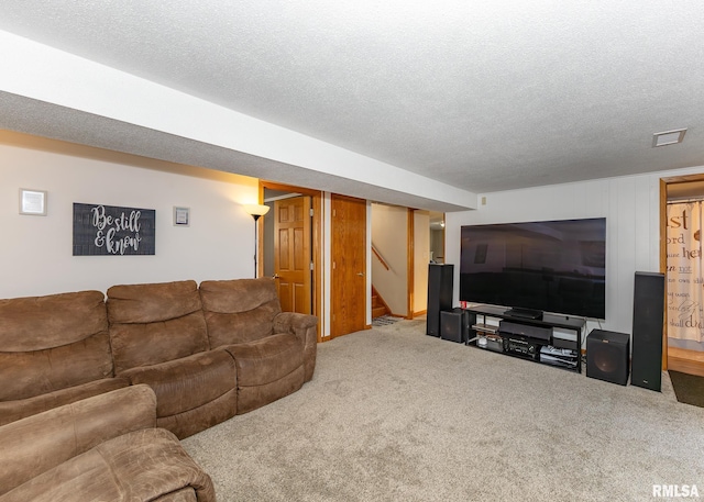 carpeted living room with a textured ceiling