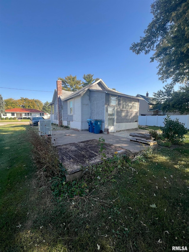 rear view of property with a yard and a patio