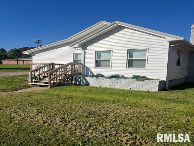 rear view of property with a lawn