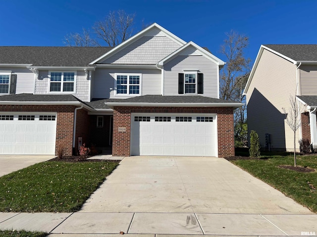 view of front of property featuring a front lawn and a garage