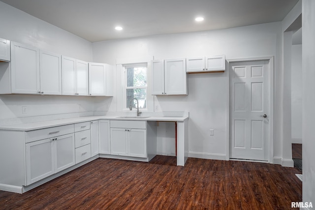 kitchen with dark wood finished floors, recessed lighting, light countertops, white cabinetry, and a sink