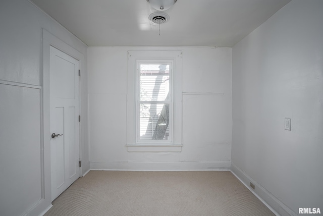 unfurnished room featuring light carpet, baseboards, and visible vents