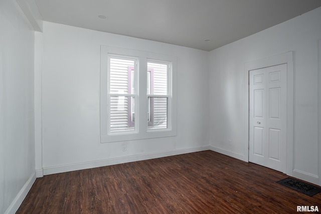 718 17th St, Rock Island, IL 61201 - spare room with dark wood finished floors, baseboards, and visible vents