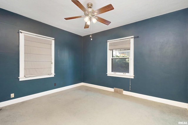 spare room featuring ceiling fan and concrete floors