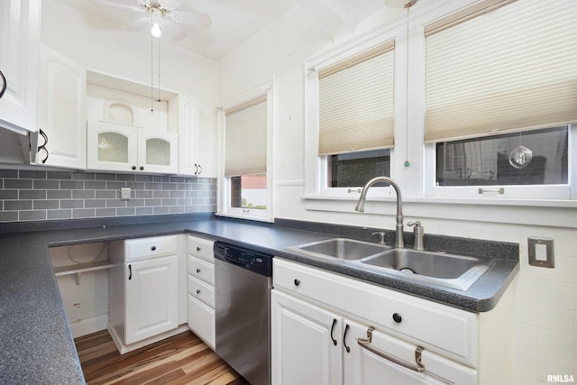 kitchen featuring hardwood / wood-style floors, sink, dishwasher, backsplash, and white cabinets