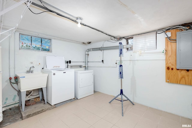 washroom featuring electric panel and washing machine and clothes dryer