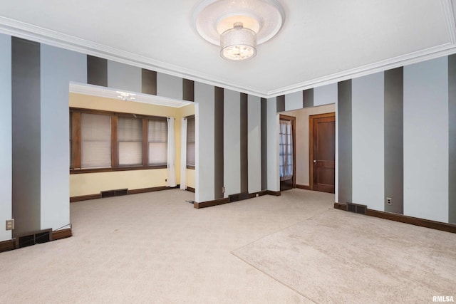 carpeted empty room featuring crown molding