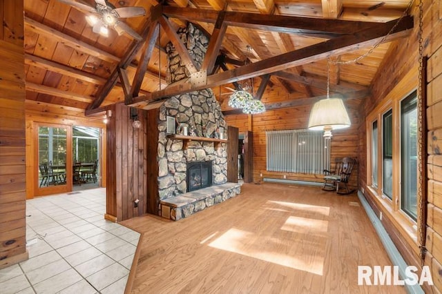 unfurnished living room featuring a fireplace, light hardwood / wood-style floors, ceiling fan, wooden ceiling, and beam ceiling