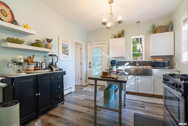 kitchen featuring appliances with stainless steel finishes, dark hardwood / wood-style floors, decorative light fixtures, and white cabinetry