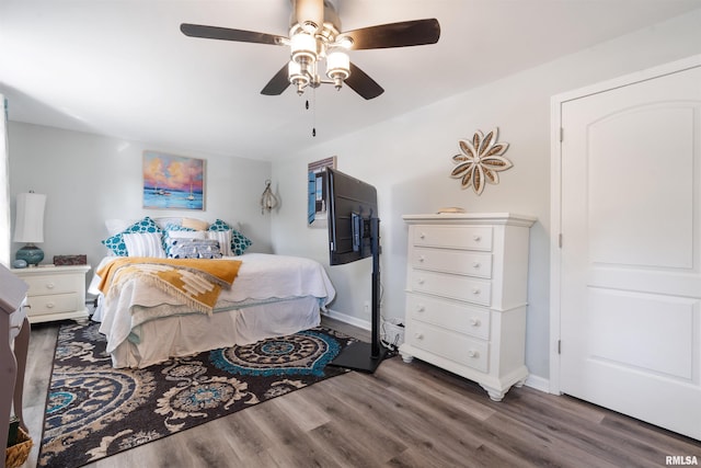 bedroom featuring ceiling fan and dark hardwood / wood-style flooring