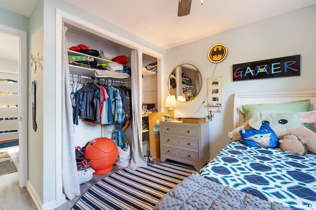 bedroom featuring ceiling fan, a closet, and wood-type flooring