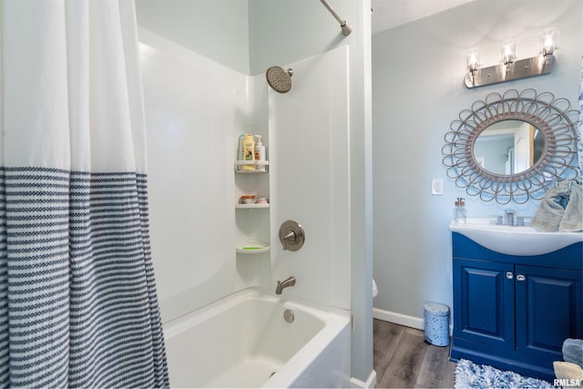 full bathroom with vanity, hardwood / wood-style flooring, shower / tub combo, and toilet